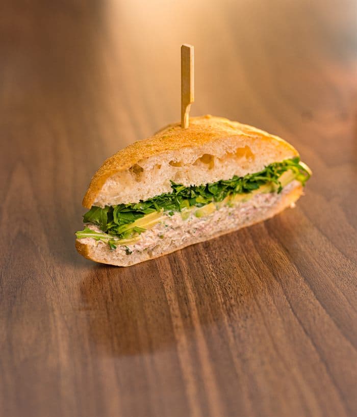 Ciabatta sandwich filled with tuna, greens and cucumber